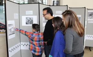 Big Read Dearborn photo - Kickoff - Sareini family viewing artwork display